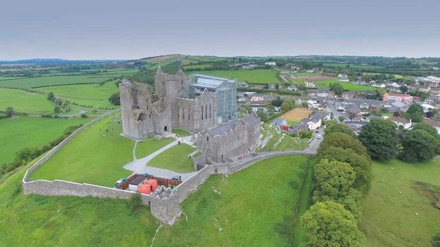 Beautiful landscape view of the Rock of Cashel it is located on a hill with lots of houses and residential areas on the city in Ireland