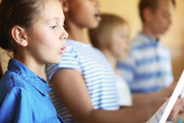 Schoolchildren singing song on music lesson