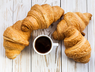 Fresh Croissants and cup of espresso. Selective focus