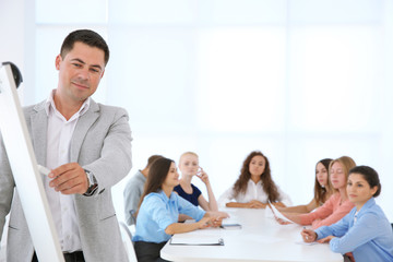 Fototapeta premium Business trainer giving presentation to group of people