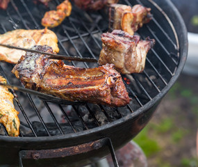Cooking grilled red meat on barbeque
