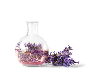 Lavender flowers and glass vase isolated on white