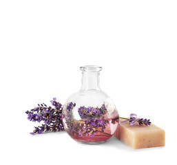 Obraz na płótnie Canvas Natural soap, lavender flowers and glass vase isolated on white