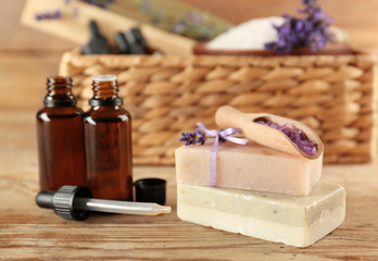 Spa concept. Lavender aroma oil, soap and sea salt on wooden background