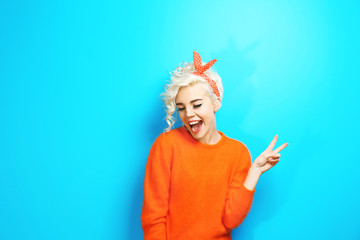 Portrait of funny emotional girl on blue background