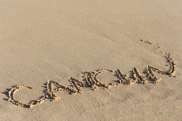 Inscription Cancun on sandy beach