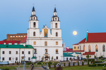 Fototapeta na wymiar Moonrise over Cathedral Of Holy Spirit In Minsk, Belarus