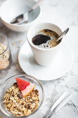 healthy breakfast: granola in bowl with coffee