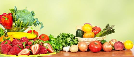 Vegetables and fruits over green background.