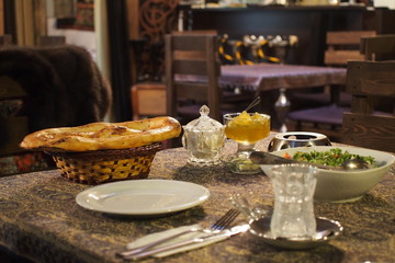 Breakfast in eastern cafe. Bread, salad, jam.