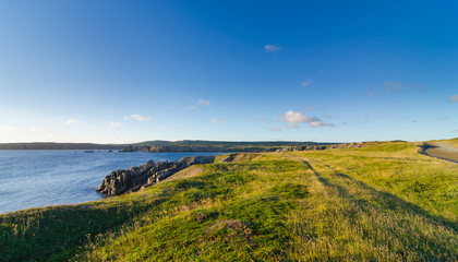 Road to Cape Bona Vista lighthouse station, Newfoundland,  Panoramic vista, bright blue late summer morning over Atlantic Canada.  