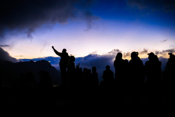 silhouette people on sunset sky