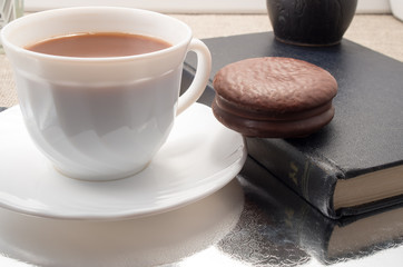 White cup of hot chocolate and cookies