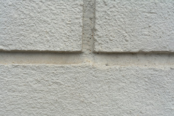 gray wall of plastered brick
