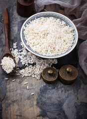 White uncooked rice on concrete background