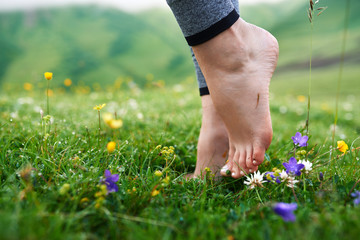 beautiful girls barefoot in cool morning dew on grass.