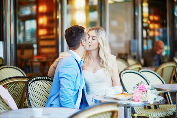 Just married couple in traditional Parisian cafe