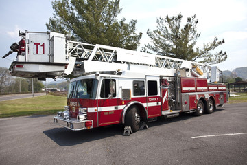 Parked fire truck with tower ladder . Horizontal.