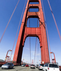 Traffic crossing the Golden Gate Bridge. Blue sky. Vertical.