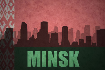 abstract silhouette of the city with text Minsk at the vintage belarus flag