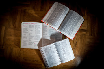 Open Recipe Books on Wooden Floor with Sunlight