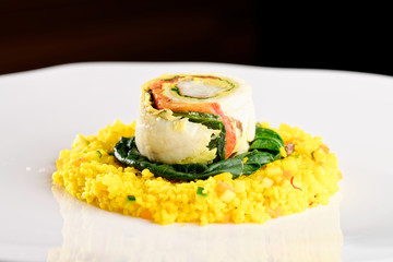 Tasty healthy fish fillet on rice and spinach