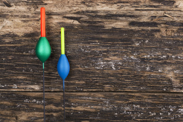 Fishing floats on wooden background © Elena Milevska