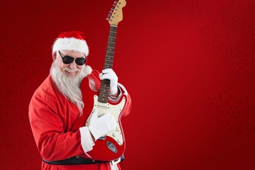 Composite image of cheerful santa claus playing guitar
