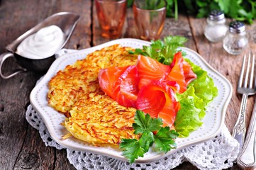 Marinated salmon in beet juice with dill and potato pancakes.