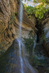 Fototapeta na wymiar Shakuranskiy waterfall in green tropical forest in Abkhazia.
