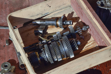 Dismantled box car transmissions. The gears on the shaft of a mechanical transmission