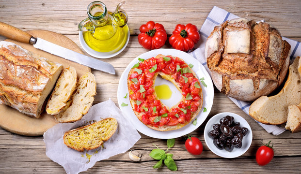 Friselle bread, tomatoes, bruschetta, olives and extra virgin olive oil