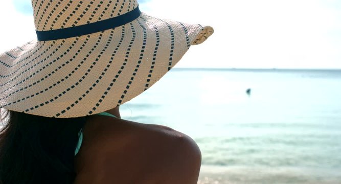 Woman Sunbathing on a Tropical Beach
