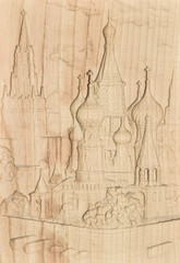 Woodcarving. Carved relief image of the Moscow Kremlin on a wooden plank