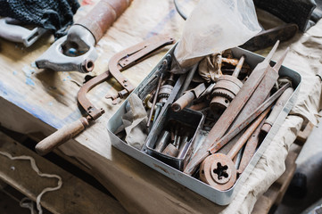 still life tool box with nails rasp and old tools
