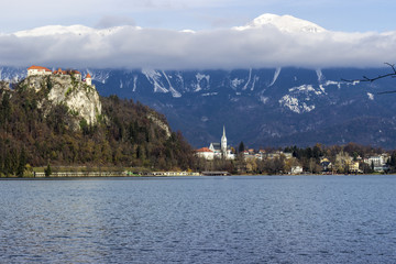 Bled castle and lake in snowy mountain background