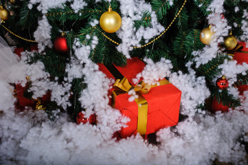 gifts under christmas tree in snow studio