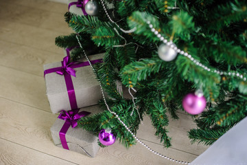 boxes under the Christmas tree with toys on branches