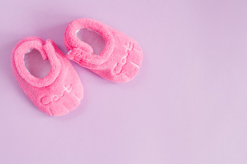 pink booties on purple background