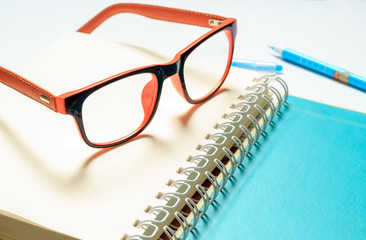 Pen and Glasses on a book