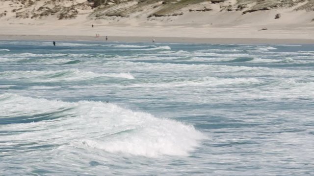 An elegant water surfer rides a nice wave and disappears in the water.