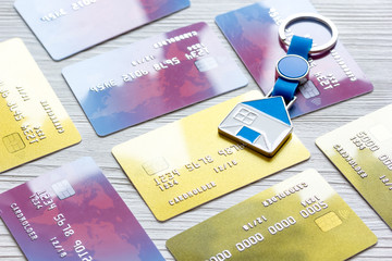 credit cards, key ring - concept mortgage on wooden background