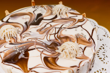 Close up of homemade pie with different chocolate ornaments on b