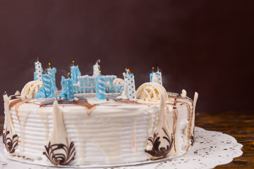 Homemade white birthday pie with lots of extinguished candles