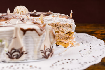 Cut pie with different chocolate ornaments stuffed with condense