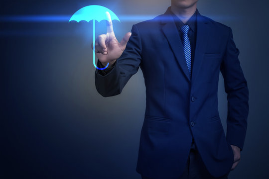 Close up of businessman touching umbrella icon, business securit - Powered by Adobe