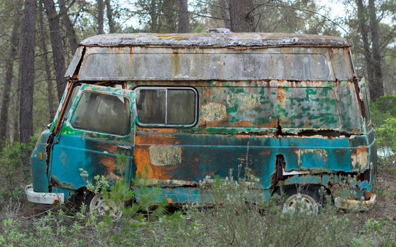 Hippie old van abandoned in forest
