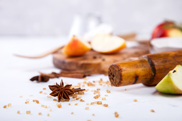 Baking Background. Ingredients  for baking Apple Pie  - apples,spices ,flour,  rolling pin, eggs, egg yolks, butter served on a white background.selective focus.Copy space.
