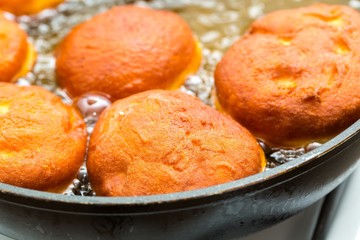 Donuts frying in deep fat