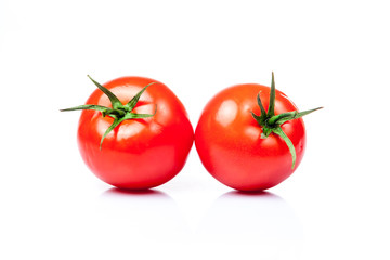 Two tomatoes isolated on a white background